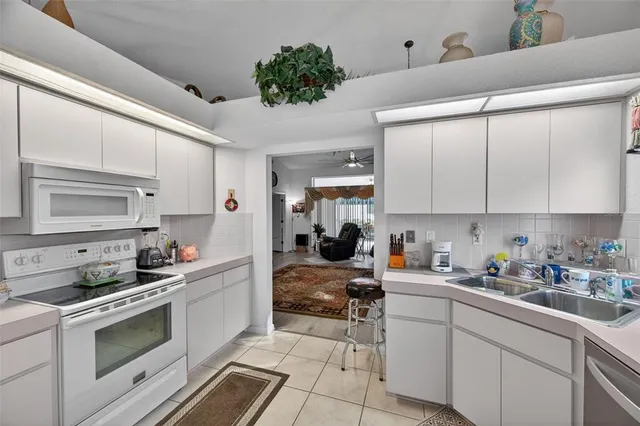 a kitchen with a refrigerator stove and sink
