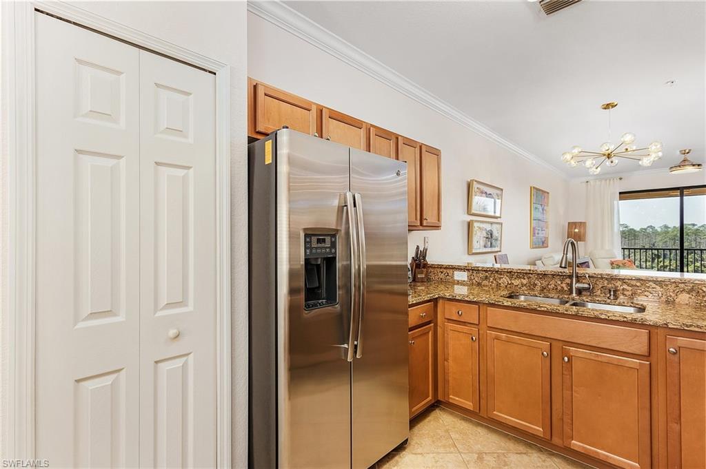 9731 Acqua Court, Unit 543 Naples, FL 34113 - Photo 5 of 24 a bathroom with a granite countertop sink and a mirror