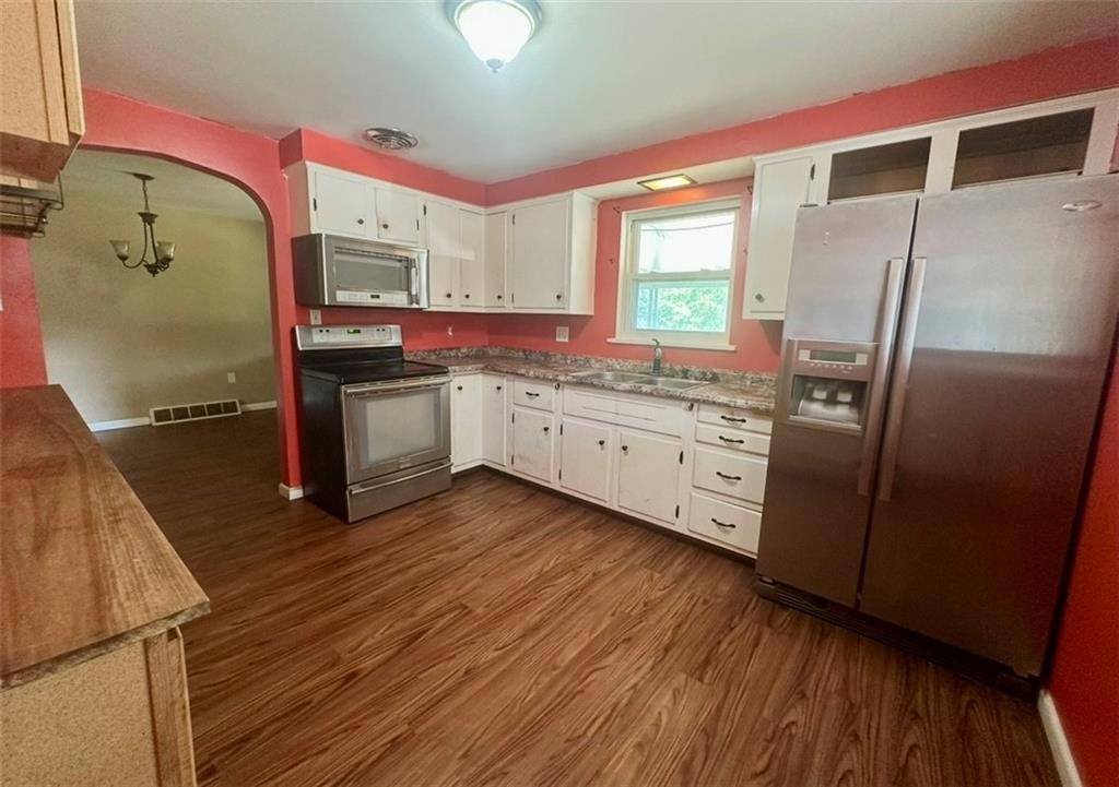 467 Big Knob Road Rochester, PA 15074 - Photo 4 of 12 a kitchen with stainless steel appliances a sink cabinets and wooden floor