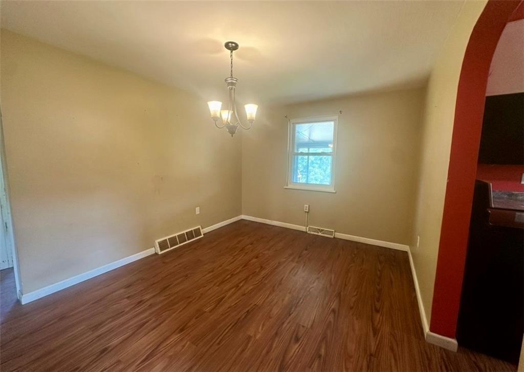 467 Big Knob Road Rochester, PA 15074 - Photo 5 of 12 an empty room with wooden floor and windows