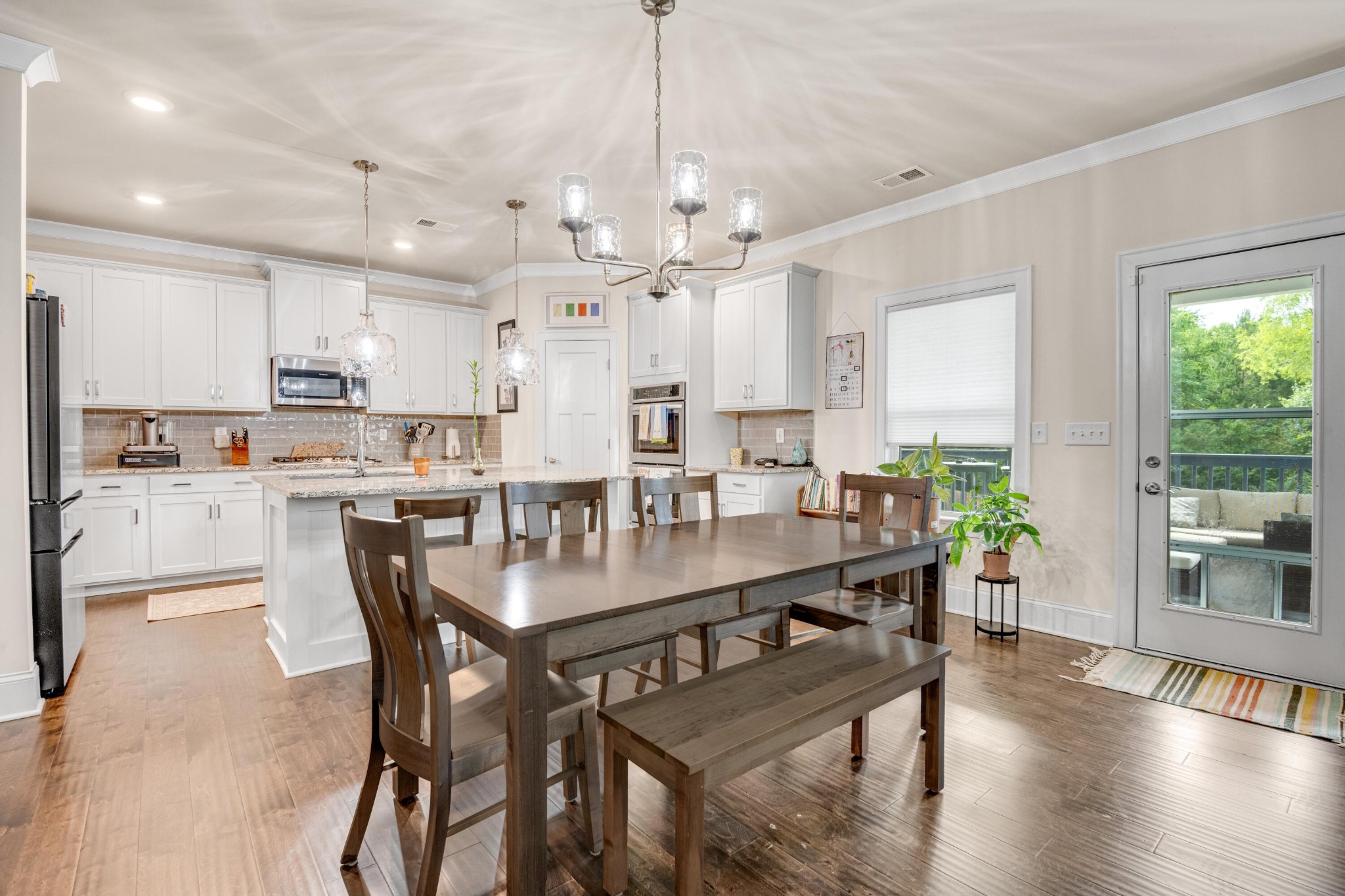 3359 Prairie Range Lane Apison, TN 37302 - Photo 34 of 71 a view of a dining room and livingroom with furniture wooden floor a chandelier