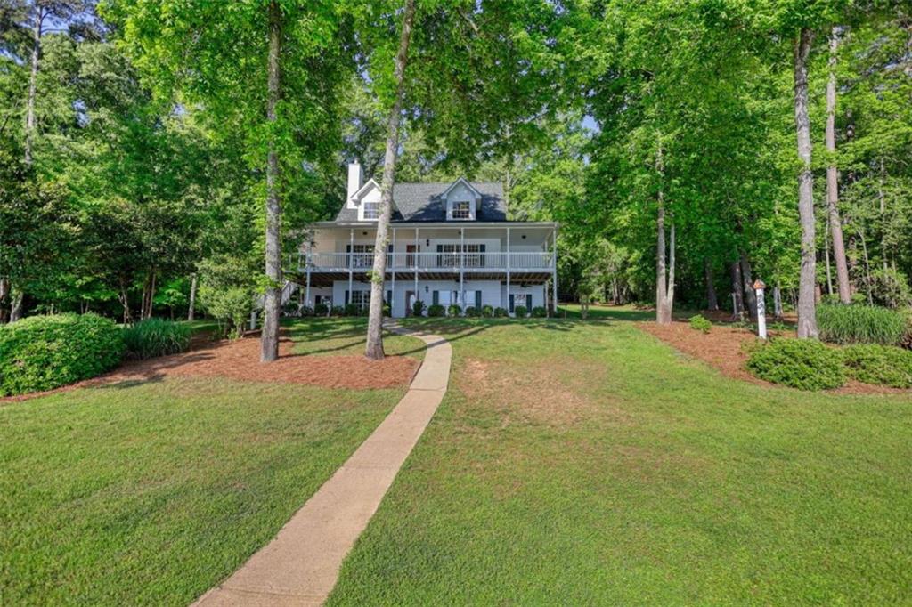 255 Old Hardy Farm Road Jackson, GA 30233 - Photo 15 of 78 a view of a house with a big yard and large trees