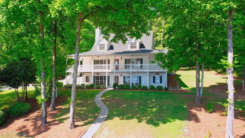 255 Old Hardy Farm Road Jackson, GA 30233 - Photo 2 of 78 a view of a house with backyard sitting area and garden