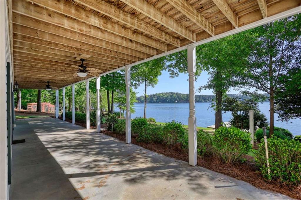 255 Old Hardy Farm Road Jackson, GA 30233 - Photo 23 of 78 a view of a patio with a table and chairs under an umbrella