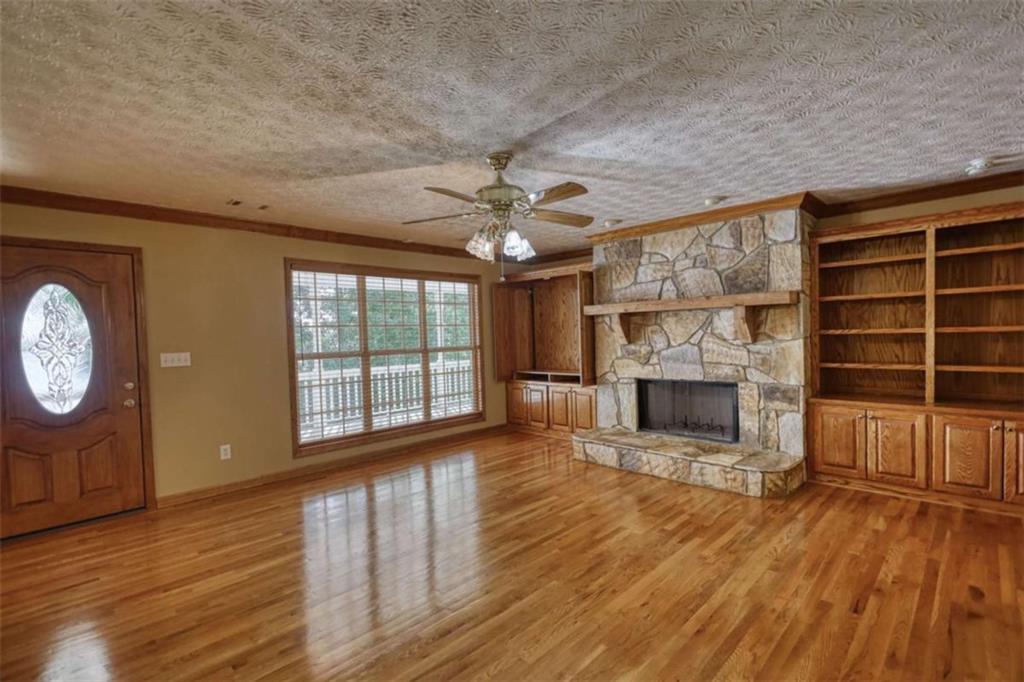 255 Old Hardy Farm Road Jackson, GA 30233 - Photo 26 of 78 a view of a livingroom with a fireplace a window and wooden floor