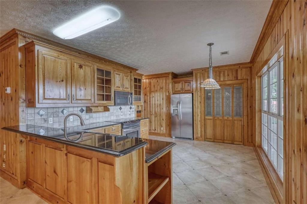 255 Old Hardy Farm Road Jackson, GA 30233 - Photo 29 of 78 a kitchen with granite countertop a sink and a refrigerator