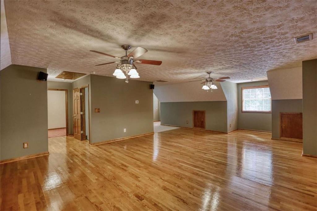 255 Old Hardy Farm Road Jackson, GA 30233 - Photo 36 of 78 a view of a livingroom with a ceiling fan window and wooden floor