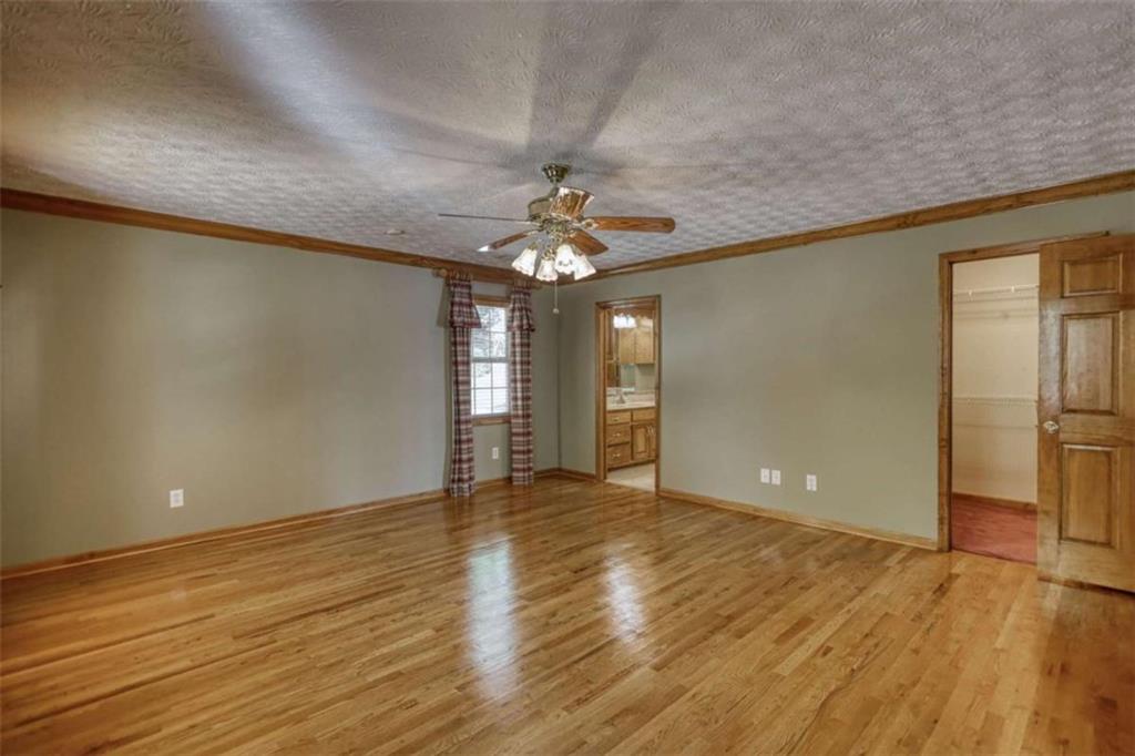 255 Old Hardy Farm Road Jackson, GA 30233 - Photo 49 of 78 a view of an empty room with window and wooden floor