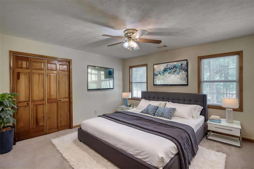 255 Old Hardy Farm Road Jackson, GA 30233 - Photo 50 of 78 a bedroom with a large bed and a chandelier