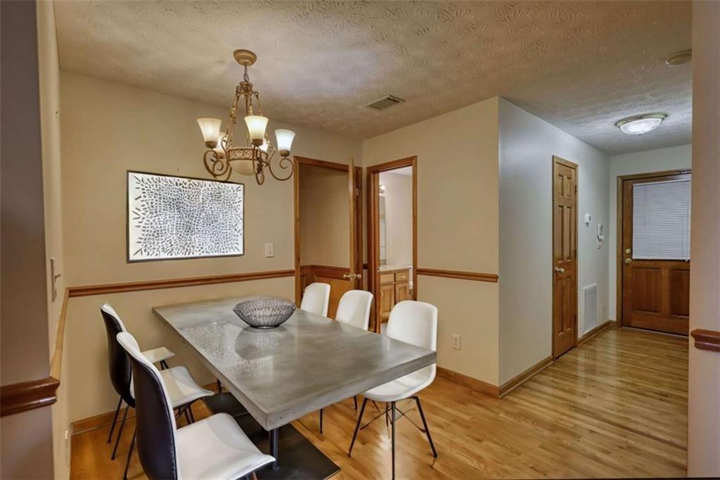 255 Old Hardy Farm Road Jackson, GA 30233 - Photo 52 of 78 a view of a dining room with furniture and wooden floor