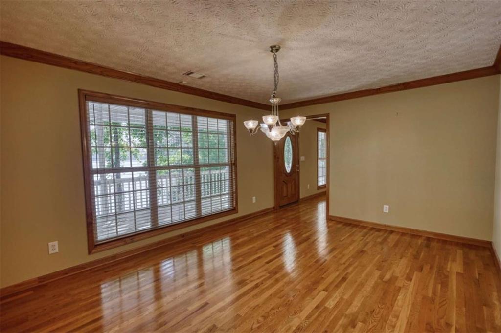 255 Old Hardy Farm Road Jackson, GA 30233 - Photo 57 of 78 a view of empty room with wooden floor and fan