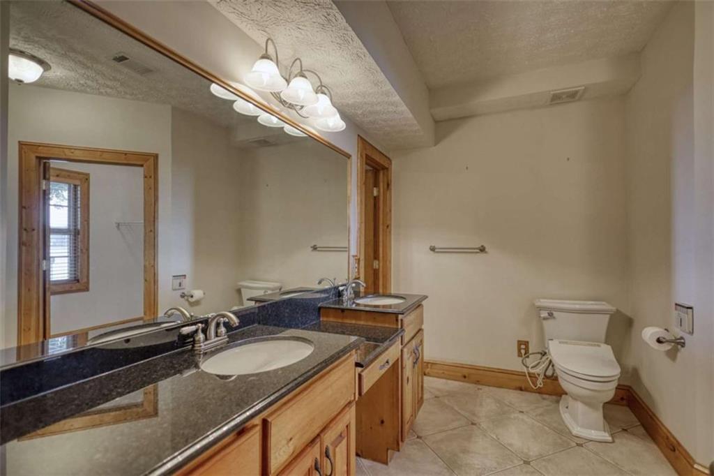 255 Old Hardy Farm Road Jackson, GA 30233 - Photo 64 of 78 a bathroom with a sink double vanity and a mirror