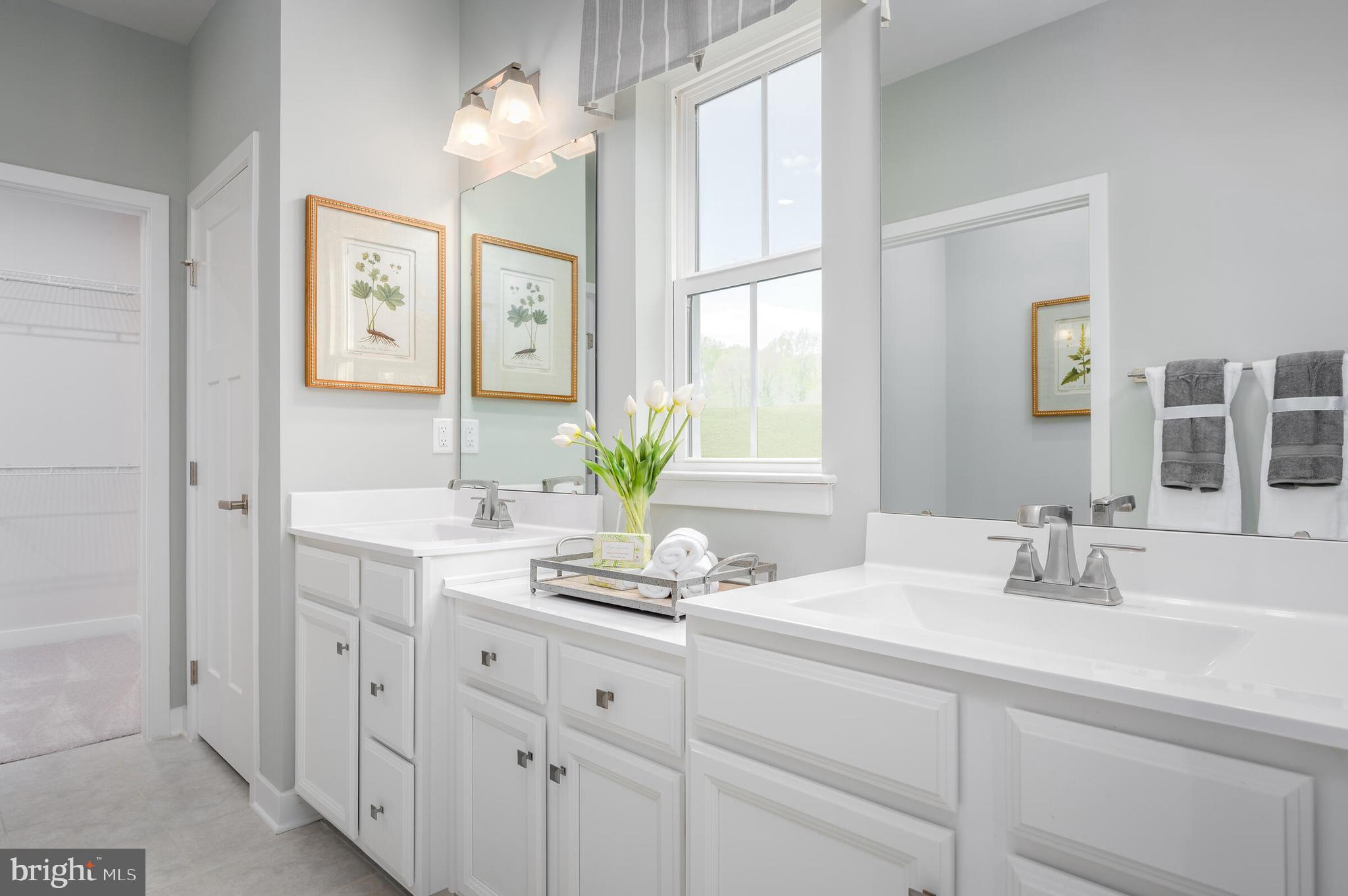 4004 Rudy Drive Sykesville, MD 21784 - Photo 17 of 24 a bathroom with double vanity and a mirror