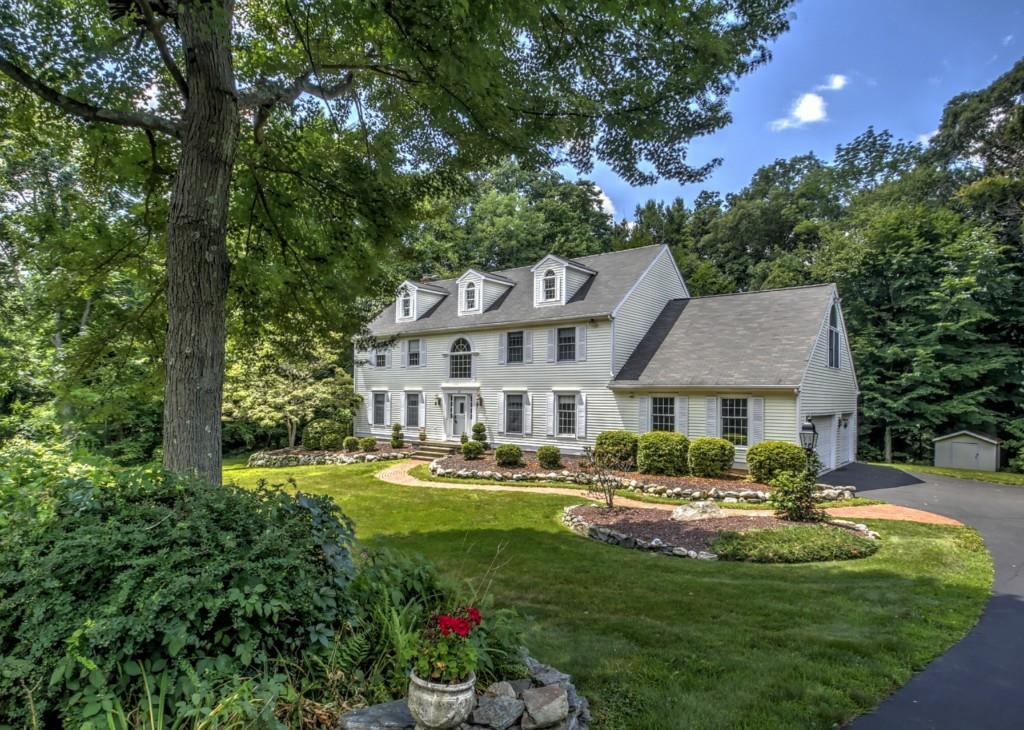 329 Laurelwood Road Orange, CT 06477 - Photo 1 of 1 a front view of a house with garden and trees