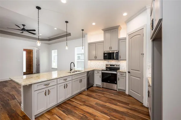 a bathroom with a granite countertop sink a large mirror and a refrigerator