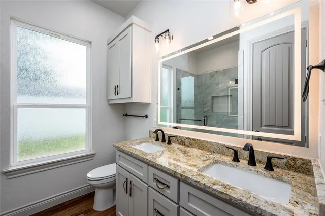 a bathroom with a window and a shower