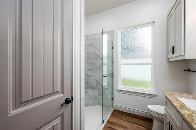 a bathroom with a glass shower door