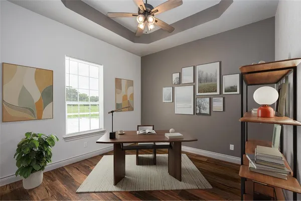 a view of a room with wooden floor and a ceiling fan