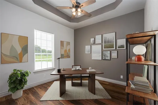 a view of a room with wooden floor and a ceiling fan