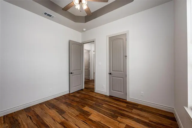 a bathroom with a granite countertop toilet sink and mirror