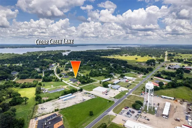 an aerial view of a house with garden space ocean and mountain view in back