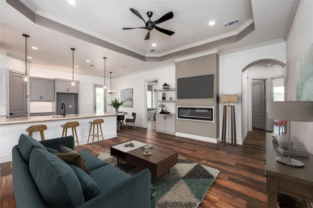 a view of a kitchen with a stove and wooden floor