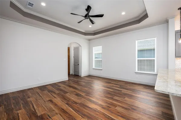 a living room with furniture a rug potted plant and a large window