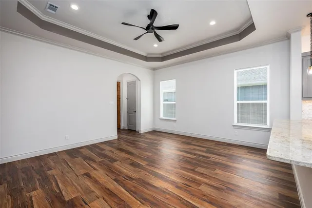 a living room with furniture a rug potted plant and a large window