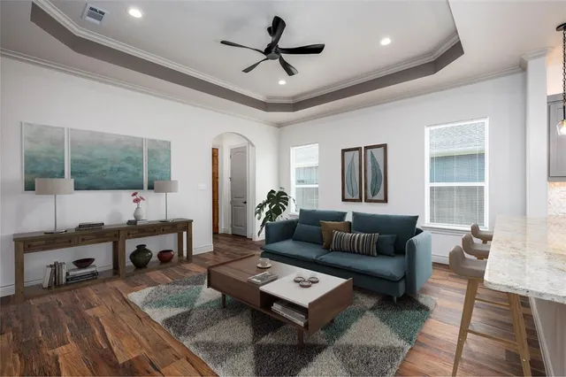 a view of a kitchen with a ceiling fan hardwood floor and a ceiling fan