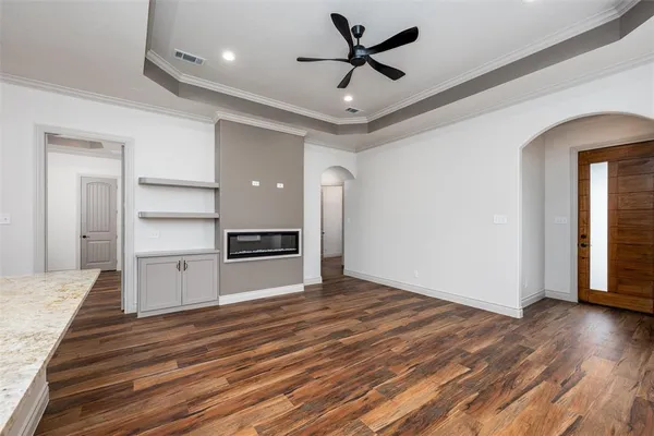 a kitchen with stainless steel appliances granite countertop a sink a refrigerator and a wooden floor