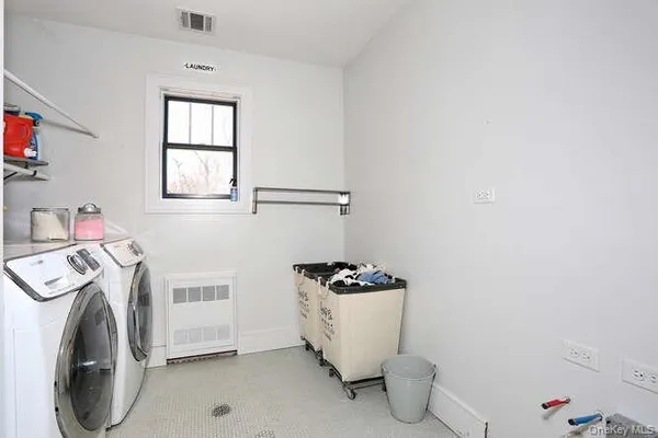 a utility room with sink dryer and washer