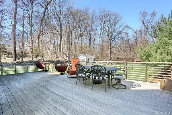 a view of a chairs and table on the wooden deck