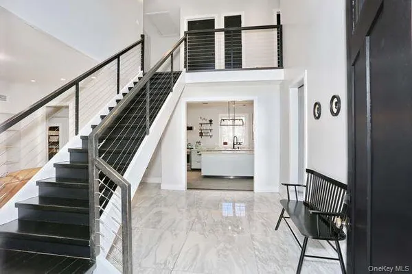 a view of entryway and hall with wooden floor