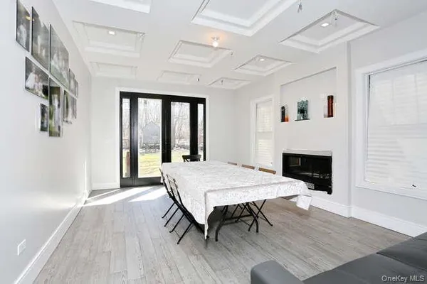 a living room with a wooden floor and a fireplace