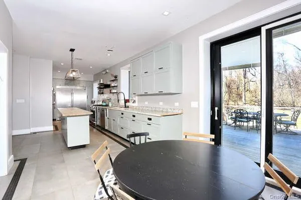 a kitchen with stainless steel appliances granite countertop a sink a stove and a refrigerator