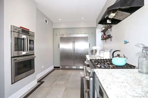a kitchen with a stove and a refrigerator
