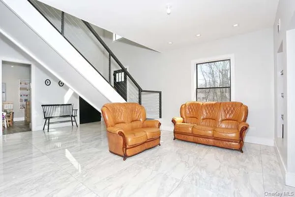 a living room with furniture and a dining room