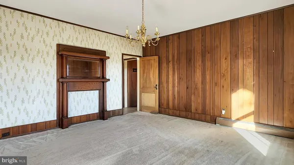 a view of an empty room with a fireplace and a window