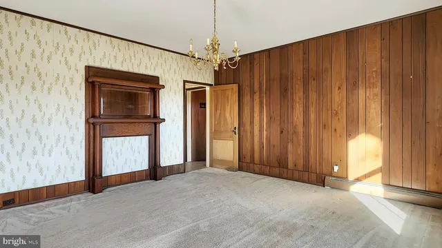 a view of an empty room with a fireplace and a window