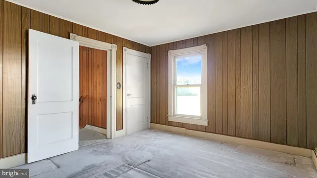 a view of room with window and wooden floor