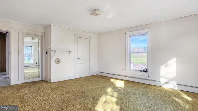 a view of a big house with a big yard and large trees