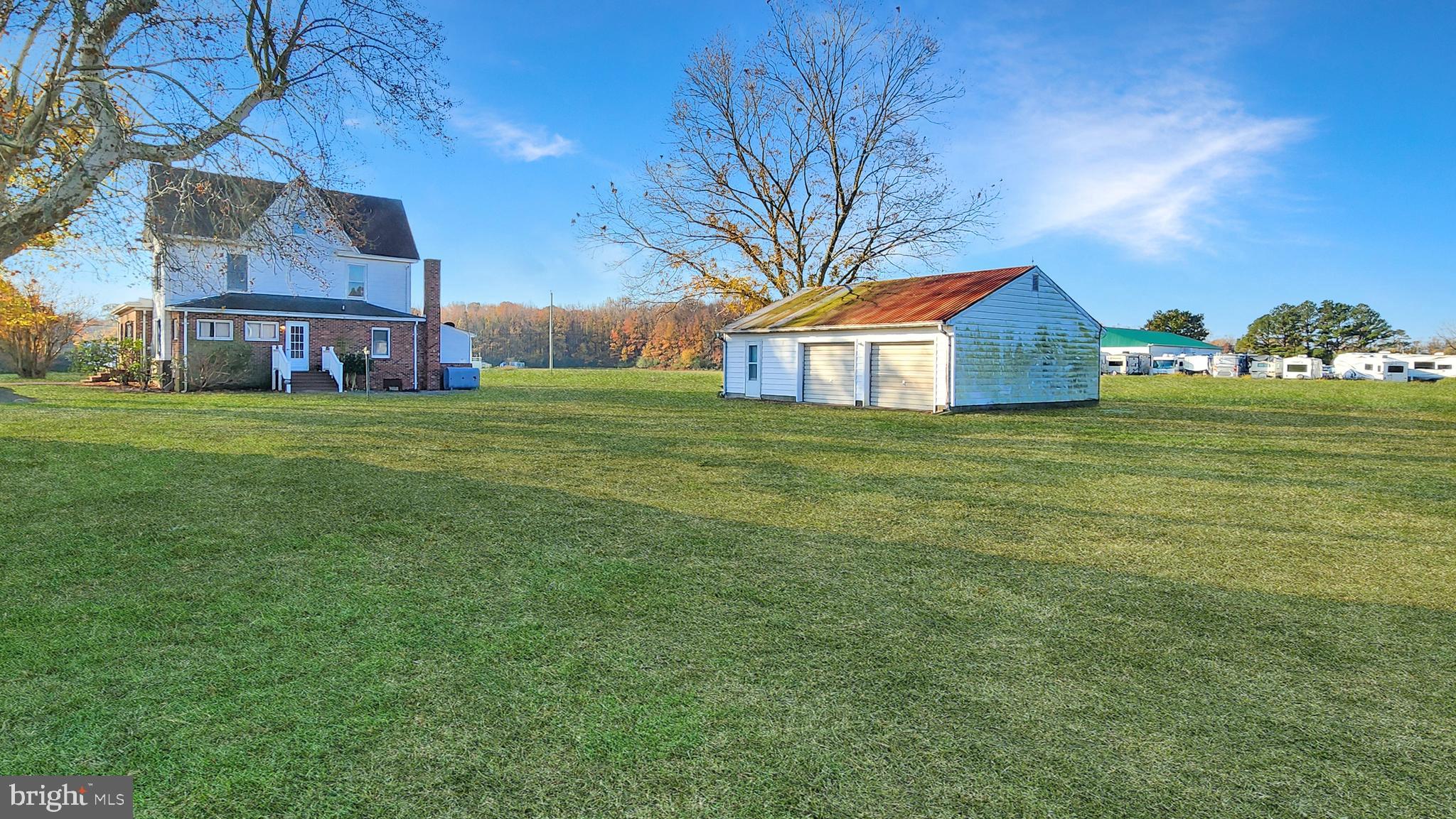 2431 Tulls Corner Road Pocomoke City, MD 21851 - Photo 24 of 28 a view of a big house with a big yard and large trees