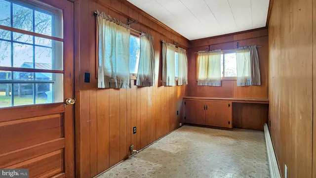 a view of a bathroom with tub and windows