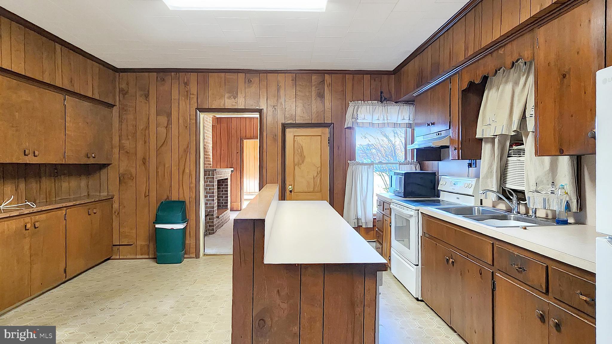 2431 Tulls Corner Road Pocomoke City, MD 21851 - Photo 5 of 28 a kitchen with a sink a refrigerator and cabinets