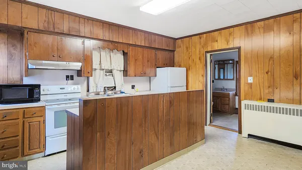 a kitchen with kitchen island cabinets and wooden floor