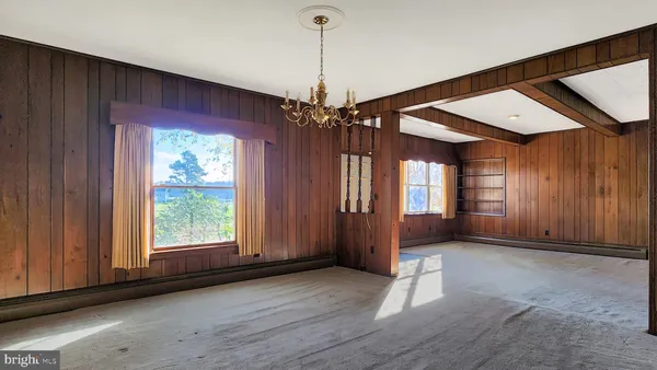 a view of a room with window and hardwood floor