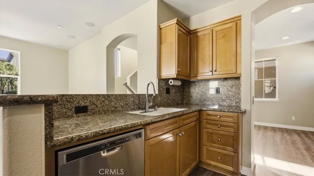 a kitchen with granite countertop a sink and a stove