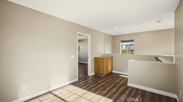 a view of a room with wooden floor