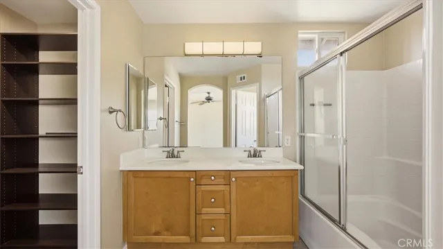 a bathroom with a granite countertop sink mirror and double