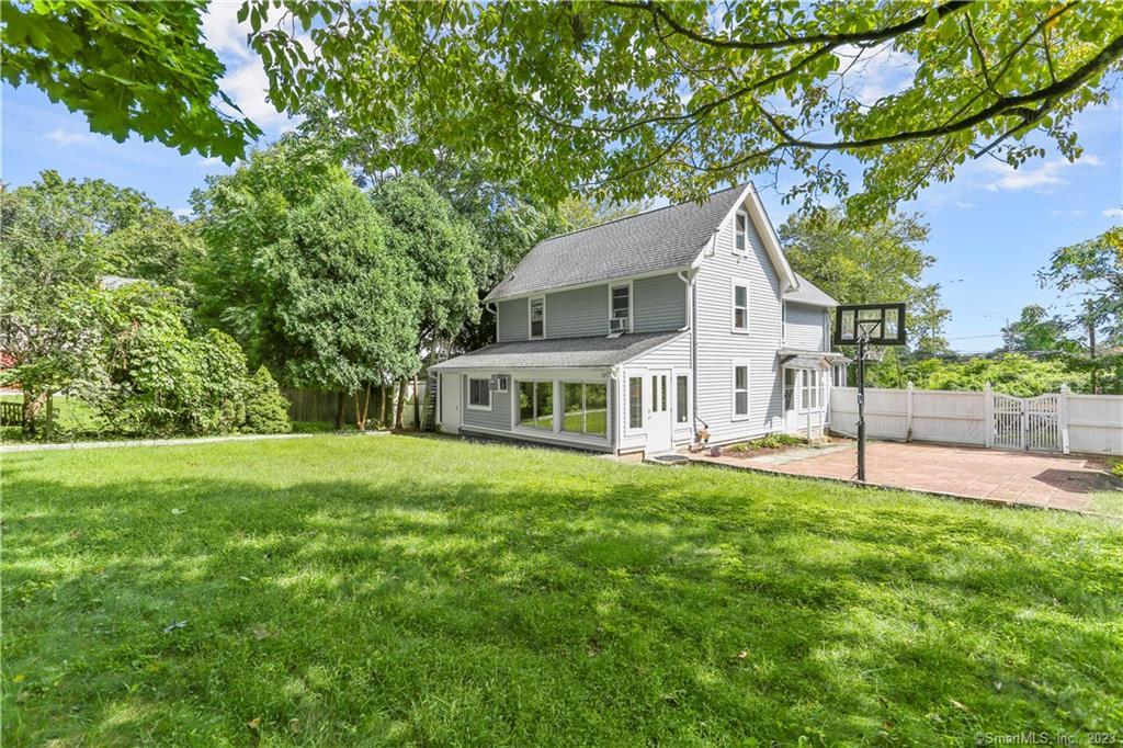 199 Bronson Road Fairfield, CT 06890 - Photo 1 of 1 a house that has a big yard with large trees